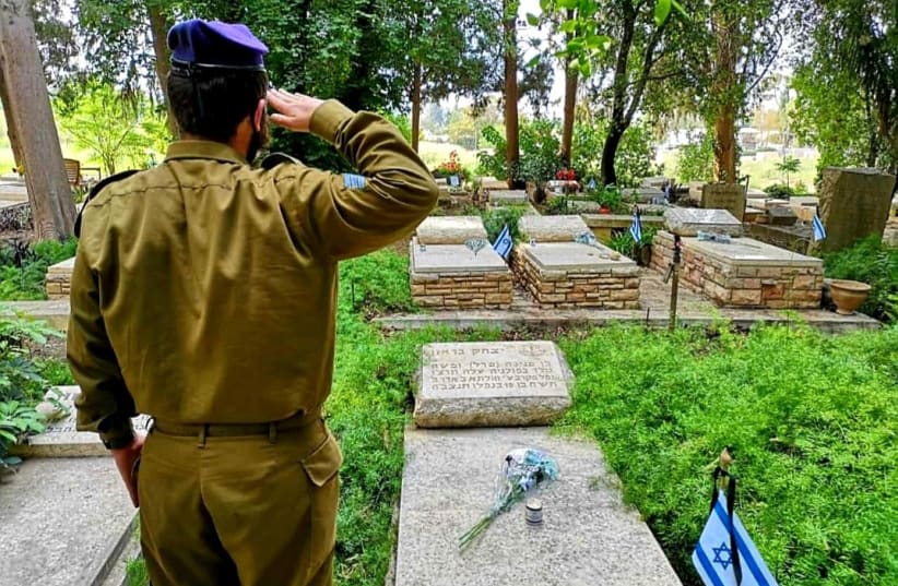 A Haredi soldier honoring the memory of those who died in the wars of the nation  (photo credit: Courtesy)