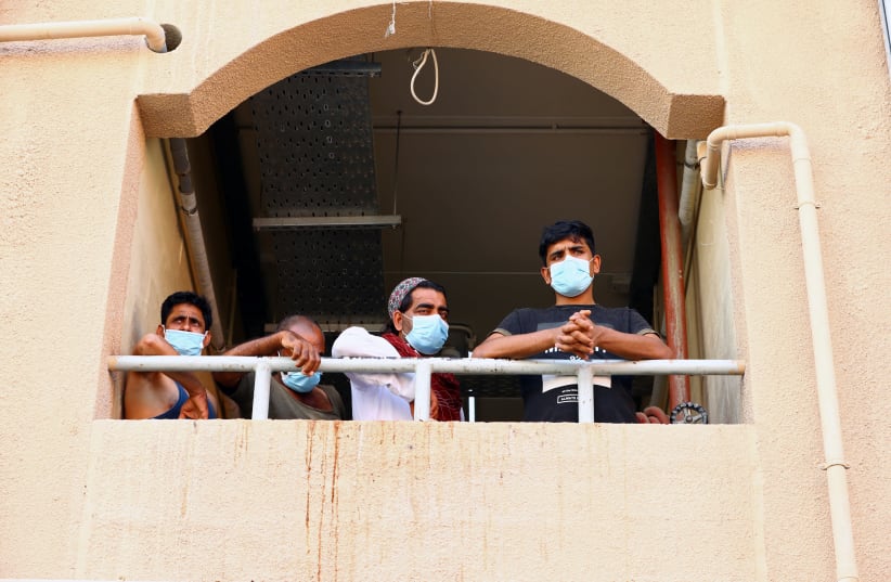 Workers wear masks during the outbreak of the coronavirus disease (COVID-19) in Dubai, United Arab Emirates April 23, 2020 (photo credit: REUTERS)