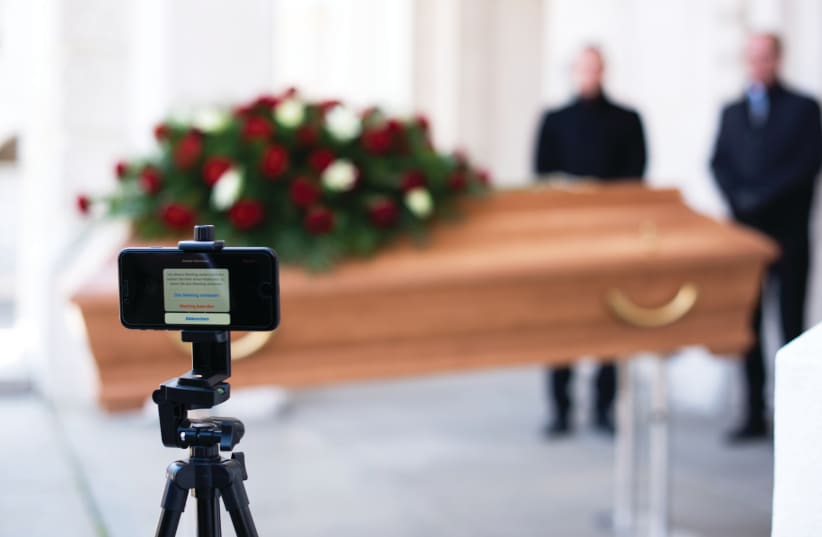 Funerals, which have been restricted to just first-degree relatives, are now taking place with participants joining through video links. (photo credit: Courtesy)