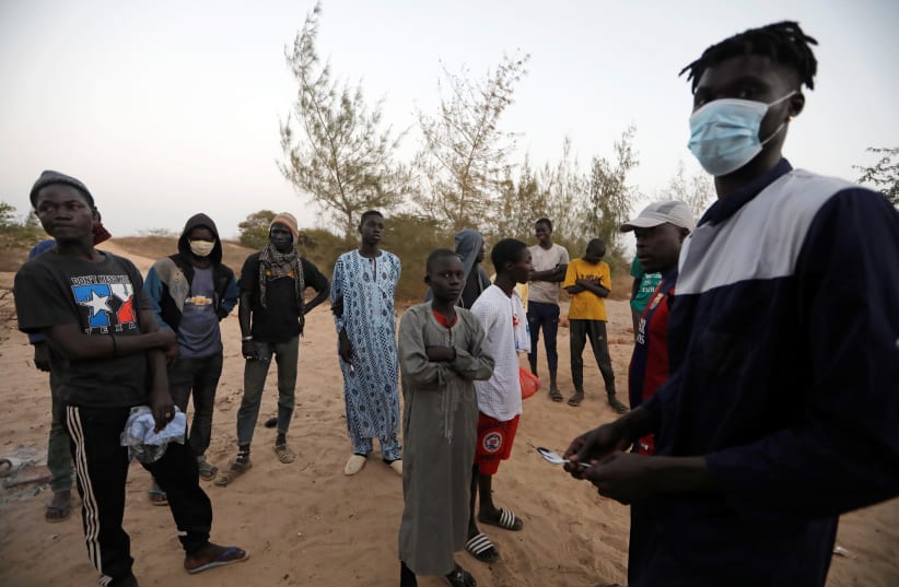 Newly arrived street children receive instructions as they settle at a camp, which the Village Pilot NGO has set up to house and confine children in need of help, amid the spread of the coronavirus disease (COVID-19), in Lac Rose, suburbs of Dakar, Senegal April 20, 2020. Picture taken April 20, 202 (photo credit: ZOHRA BENSEMRA/REUTERS)