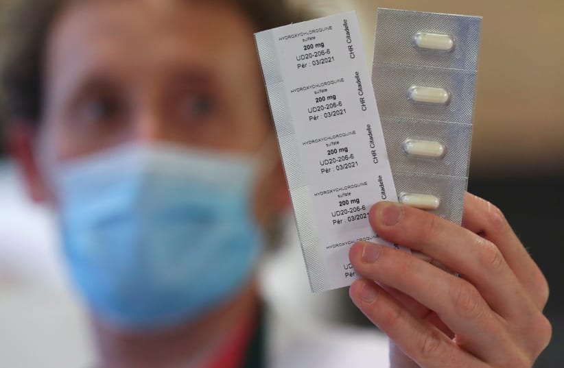 A pharmacy worker shows pills of hydroxychloroquine used to treat the coronavirus disease (COVID-19) at the CHR Centre Hospitalier Regional de la Citadelle Hospital in Liege, Belgium, April 22, 2020. (photo credit: YVES HERMAN / REUTERS)