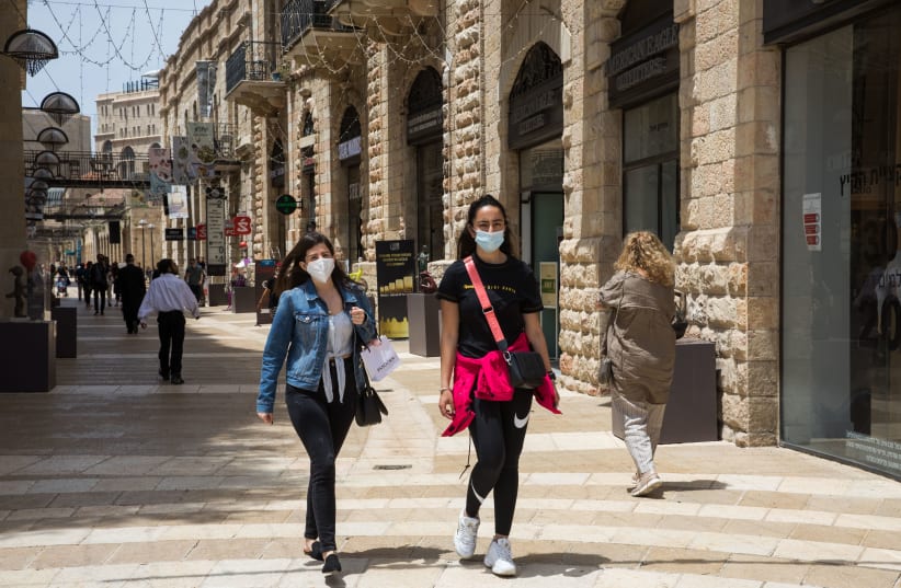 People walk at the Mamilla Mall near Jerusalem's Old City on May 3, 2020. (photo credit: NATI SHOHAT/FLASH90)