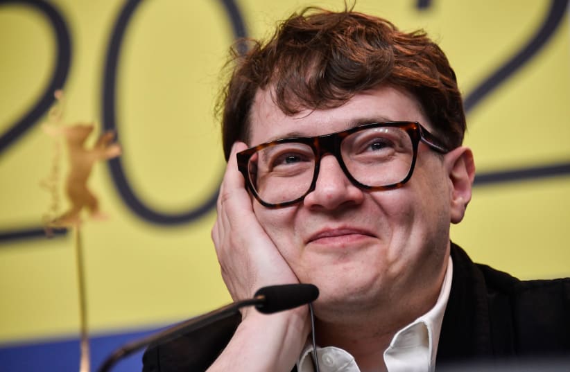 Russian director Ilya Khrzhanovsky smiling at a press conference for the film "Dau: Natasha" screened in competition in Berlin, Germany on February 26, 2020. (photo credit: JOHN MACDOUGALL/AFP VIA GETTY IMAGES/JTA)