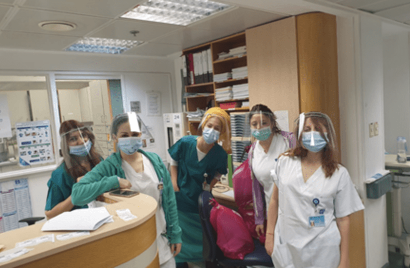 Medical staff of the Department of Cardiology, Hadassah Ein Kerem wearing face shields designed by students of Bezalel Academy of Arts and Design, Jerusalem (photo credit: Courtesy)
