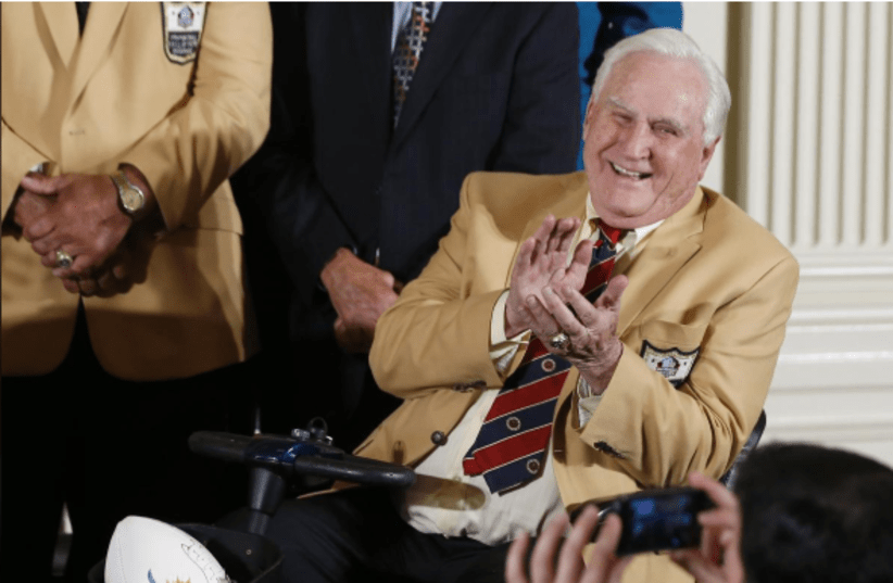 Don Shula, coach of the 1972 season NFL Super Bowl winning football team Miami Dolphins, is pictured with a football in his mobility scooter's basket during a ceremony in the East Room of the White House in Washington, August 20, 2013 (photo credit: REUTERS/JASON REED)