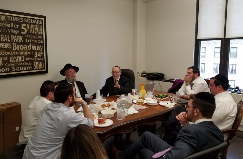 Rabbi Elya Brudny and the late Mendy Klein hold a staff meeting at Amudim’s main  (photo credit: Courtesy)