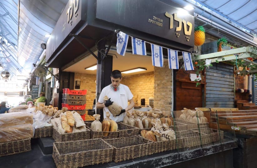 Mahane Yehuda market reopens after coronavirus restrictions had it shut down for the most part (photo credit: MARC ISRAEL SELLEM)