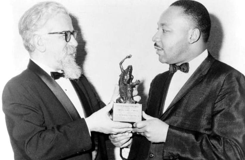 RABBI ABRAHAM JOSHUA HESCHEL presents a Judaism and World Peace award to Dr. Martin Luther King, Jr. in 1965. (photo credit: Wikimedia Commons)