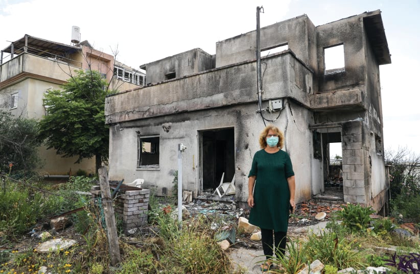 ZELDA BURKEY outside her burned-out house: The country and people around the world opened their hearts and hands (photo credit: MARC ISRAEL SELLEM/THE JERUSALEM POST)