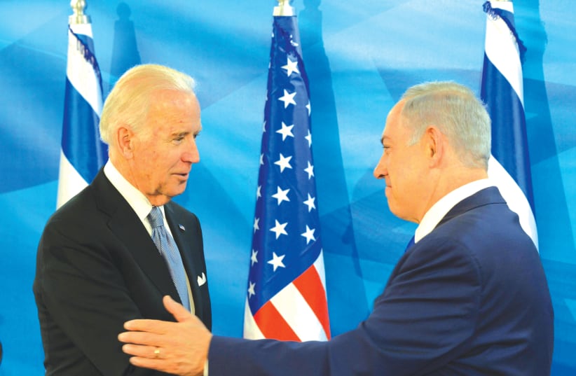 THEN-US vice president Joe Biden embraces Prime Minister Benjamin Netanyahu in Jerusalem in 2016. (photo credit: AMOS BEN-GERSHOM/GPO)