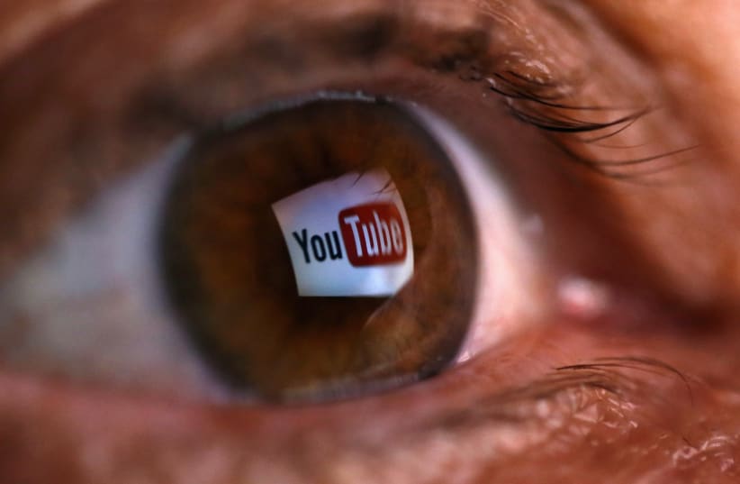 A picture illustration shows a YouTube logo reflected in a person's eye, in central Bosnian town of Zenica (photo credit: REUTERS)