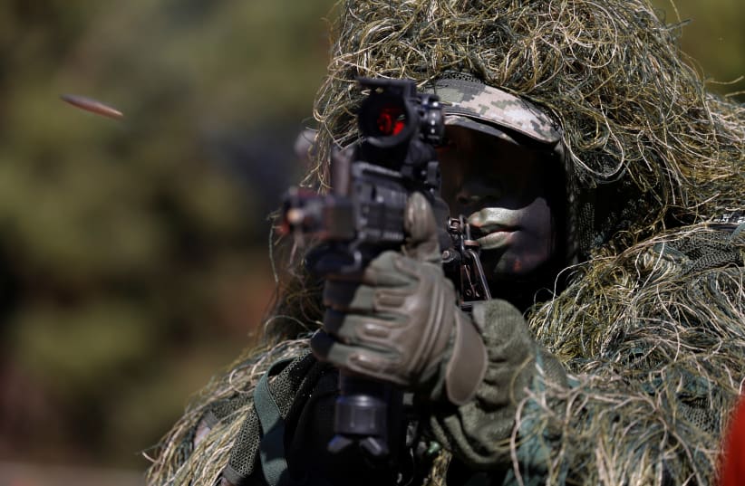 A South Korean marine in action during their regular drill on Yeonpyeong Island, South Korea November 1, 2018 (photo credit: REUTERS)