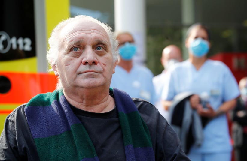 Italian COVID-19 patient from Bergamo bids farewell from the university clinic Saint Josef in Bochum. May 9, 2020 (photo credit: REUTERS/WOLFGANG RATTAY)