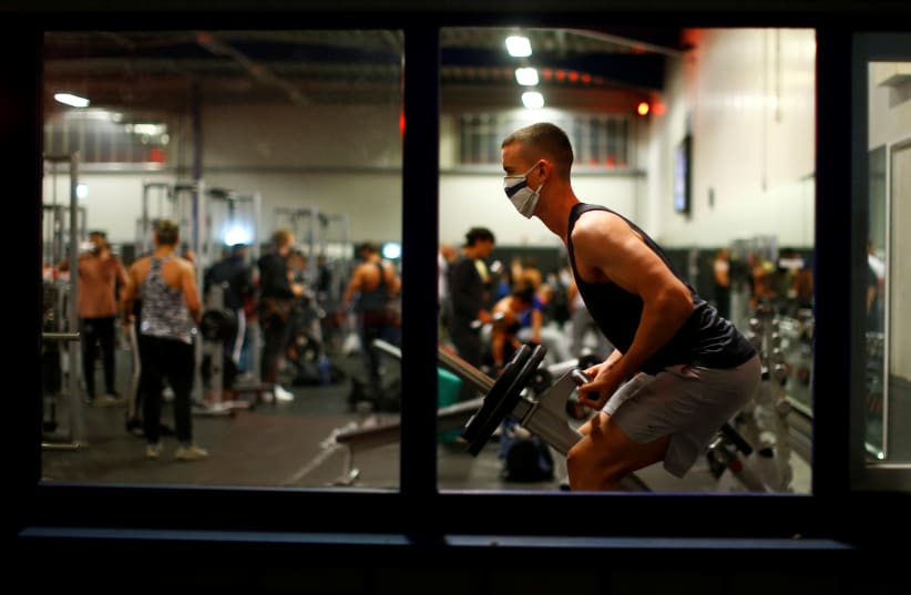 Fitness studio reopens following weeks of closure due to global outbreak of the coronavirus disease (photo credit: REUTERS)
