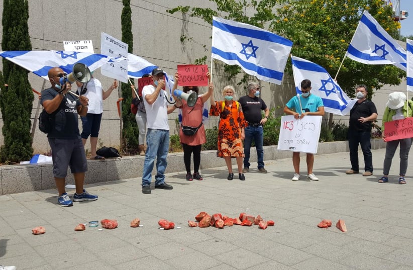 Israeli parents protesting current IDF policy in combating terror, the red rocks are meant to show that stone-throwing can kill  (photo credit: IM TIRTZU)