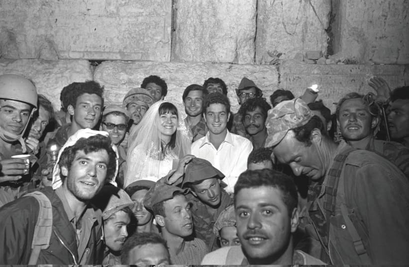 A PARATROOPER who took part in the battle for Jerusalem’s Old City celebrates his wedding in front of the Western Wall on June 9, 1967. (photo credit: Wikimedia Commons)