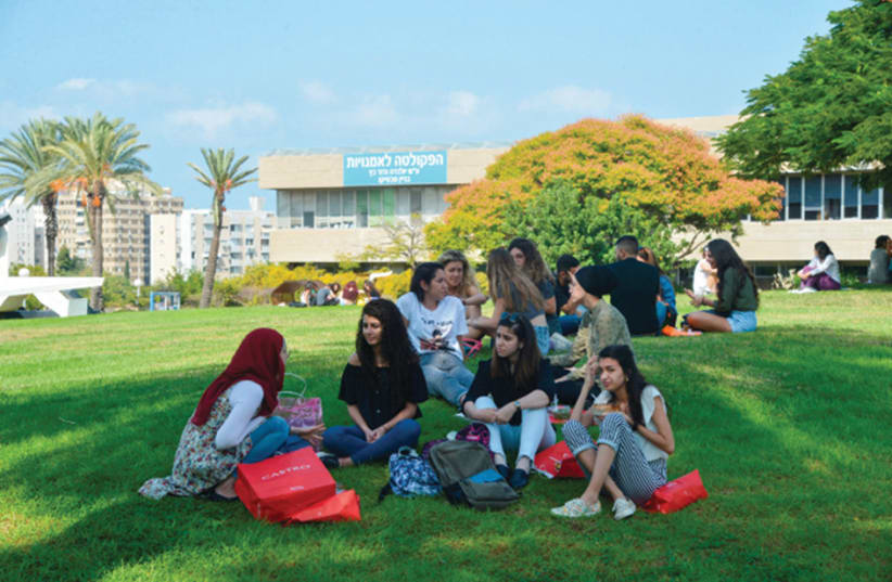 Tel Aviv University students relax on the first day of the new academic year, in October 2018. (photo credit: FLASH90)