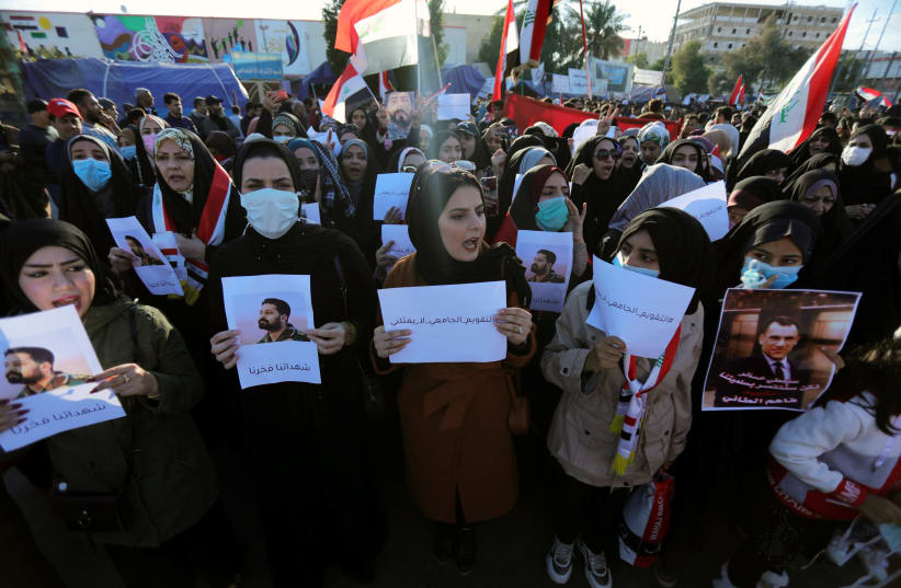 Iraqi women demonstrators hold signs during ongoing anti-government protests in Kerbala, Iraq January 10, 2020 (photo credit: REUTERS/ABDULLAH DHIAA AL-DEEN)