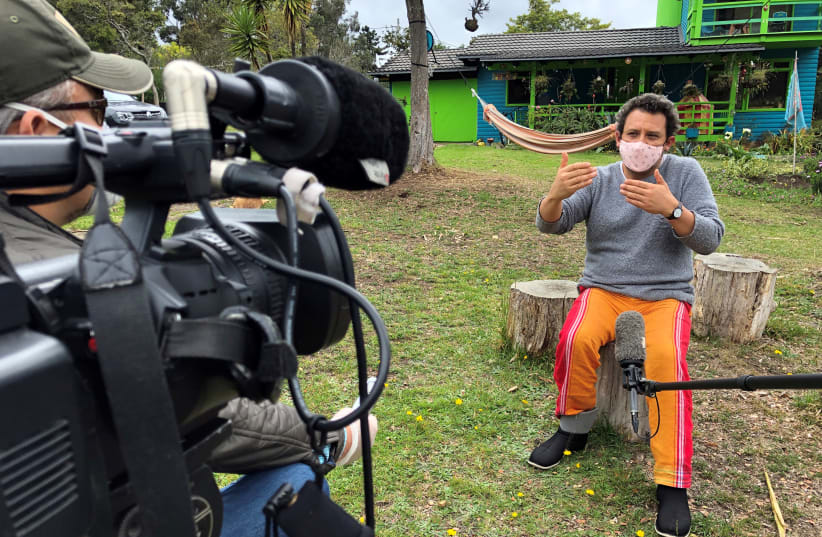 Colombian film director Harold Trompetero, wearing a face mask, speaks during an interview with Reuters, amid the coronavirus disease (COVID-19) outbreak in La Calera, Colombia, May 15, 2020. Picture taken May 15, 2020 (photo credit: REUTERS/ANDRES ROJAS)