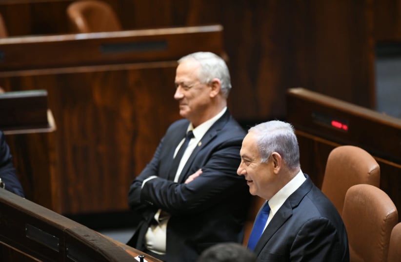 Prime Minister Benjamn Netanyahu and Defense Minister Benny Gantz at the swearing in of the new government (photo credit: AMOS BEN-GERSHOM/GPO)