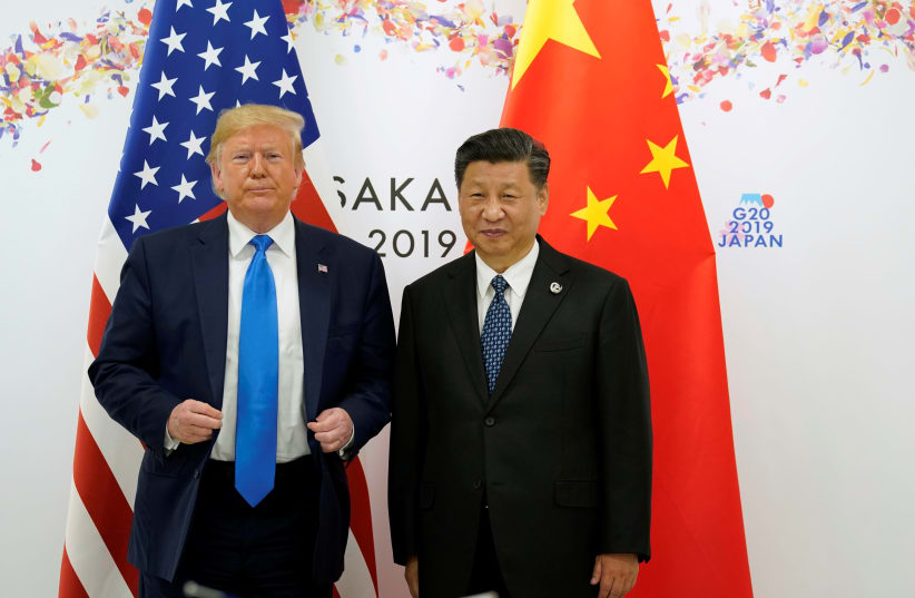 US PRESIDENT Donald Trump and Chinese President Xi Jinping stand side by side at the G20 leaders summit in Japan last year (photo credit: KEVIN LAMARQUE/REUTERS)