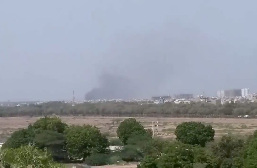A plume of smoke is seen after the crash of a PIA aircraft in Karachi, Pakistan May 22, 2020 (photo credit: TWITTER/SHAHABNAFEES VIA REUTERS)