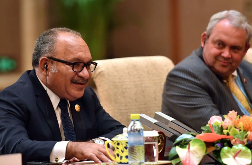 Prime Minister of Papua New Guinea Peter O'Neill speaks to Chinese Premier Li Keqiang (not pictured) during their meeting at the Diaoyutai State Guesthouse in Beijing, China, April 26, 2019. (photo credit: PARKER SONG/POOL VIA REUTERS)