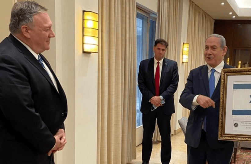 Prime Minister Benjamin Netanyahu gifting Pompeo with Israeli flag made from tradition blue dye (photo credit: Courtesy)