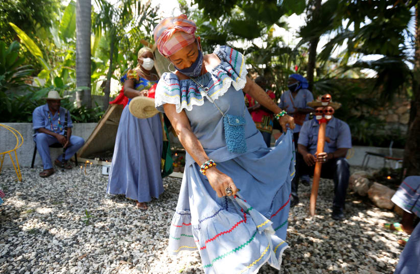 A Mambo, a voodoo priestess, dances as she takes part in a ceremony in Port-au-Prince, Haiti May 1, 2020. (photo credit: REUTERS/JEANTY JUNIOR AUGUSTIN)
