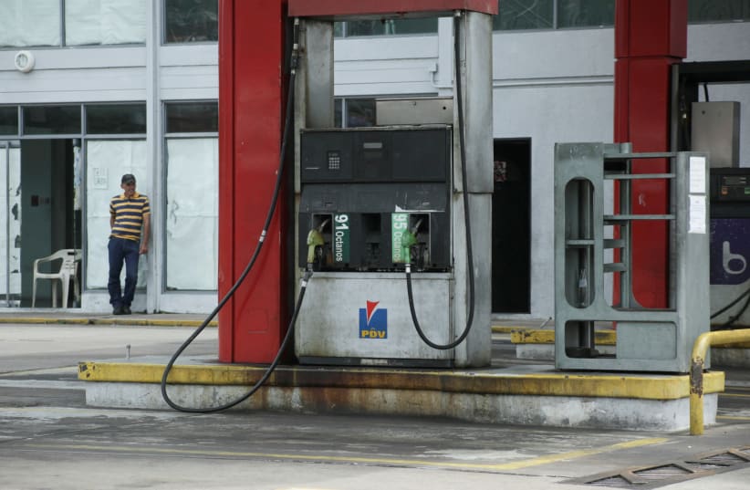 A worker stands at a closed gas station of the state oil company PDVSA in San Cristobal, Venezuela, May 17, 2019 (photo credit: REUTERS/CARLOS EDUARDO)