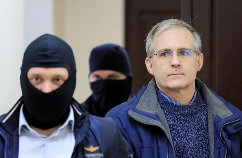 Former US Marine Paul Whelan, who was detained and accused of espionage, is escorted inside a court building in Moscow (photo credit: REUTERS)