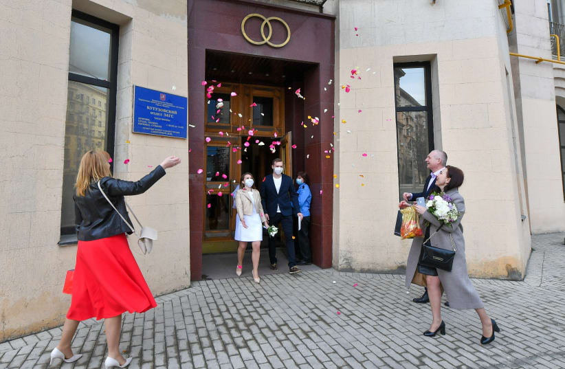 THE WEDDING is great, but in real life getting to ‘happily ever after’ is not always easy.  (Pictured: A newly wed couple outside a Moscow marriage registration palace) (photo credit: REUTERS)