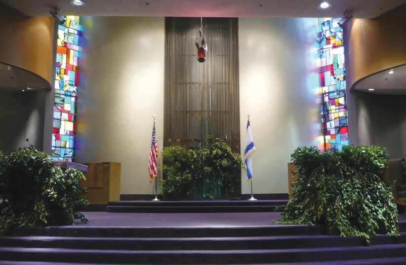 AN AMERICAN synagogue sanctuary adorned with greenery in honor of Shavuot. (photo credit: Wikimedia Commons)