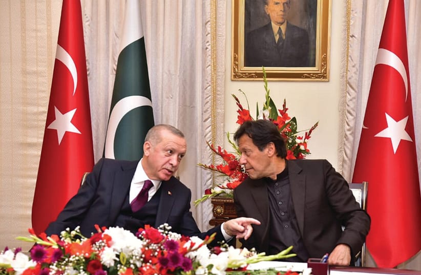PAKISTAN’S PRIME MINISTER Imran Khan (right) and Turkish President Tayyip Erdogan speak during an agreement signing ceremony in Islamabad, in February. (photo credit: REUTERS)