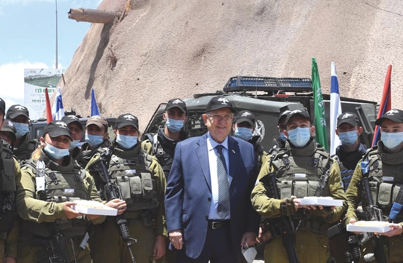 PRESIDENT REUVEN RIVLIN gives cheesecake and cold lemonade to soldiers from the Erez Brigade. (photo credit: MARK NEYMAN/GPO)