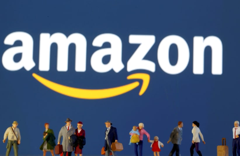 Small toy figures are seen in front of diplayed Amazon logo (photo credit: REUTERS/ DADO RUVIC)
