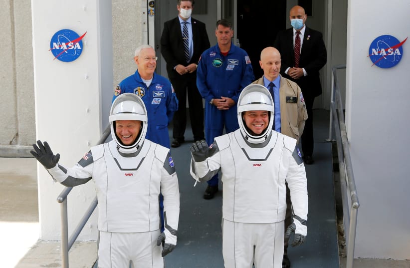 NASA astronauts Douglas Hurley and Robert Behnken head to Pad39A before the launch of a SpaceX Falcon 9 rocket and Crew Dragon spacecraft at the Kennedy Space Center, in Cape Canaveral, Florida, U.S., May 27, 2020 (photo credit: REUTERS/JOE SKIPPER)