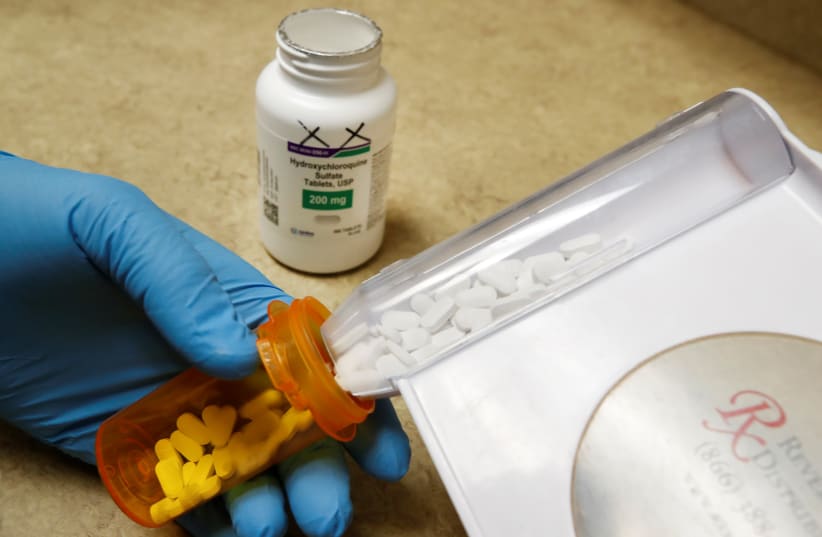 The drug hydroxychloroquine, pushed by U.S. President Donald Trump and others in recent months as a possible treatment to people infected with the coronavirus disease (COVID-19), is displayed by a pharmacist at the Rock Canyon Pharmacy in Provo, Utah, US, May 27, 2020 (photo credit: GEORGE FREY/ REUTERS)