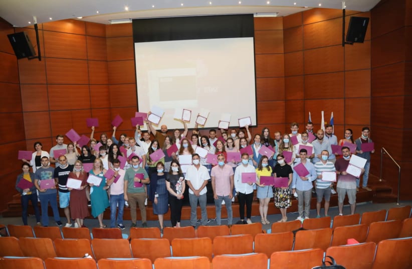 Medical interns from Eastern Europe celebrate the awarding of their medical certification at Rambam Hospital in Haifa. (photo credit: PIOTR FLITR FOR RAMBAM)