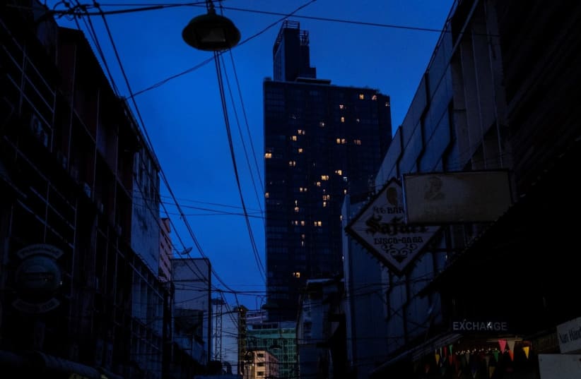 General view of the almost empty Patpong nightlife and sex trade district, which is usually crowded with tourists, during the coronavirus disease (COVID-19) outbreak in Bangkok, Thailand, May 26, 2020. (photo credit: ATHIT PERAWONGMETHA / REUTERS)