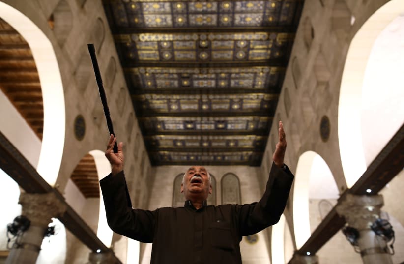 A worshipper prays inside al-Aqsa mosque on the compound known to Muslims as the Noble Sanctuary and to Jews as the Temple Mount, as it reopened to worshippers after a two-and-a-half month closure due to the outbreak of the coronavirus disease (COVID-19), in Jerusalem's Old City May 31, 2020 (photo credit: AMMAR AWAD/REUTERS)