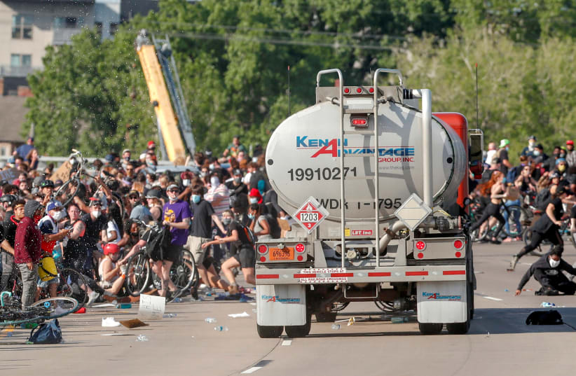 A tanker truck drives into thousands of protesters marching on 35W north bound highway during a protest against the death in Minneapolis police custody of George Floyd, in Minneapolis, Minnesota, US May 31, 2020 (photo credit: ERIC MILLER/REUTERS)