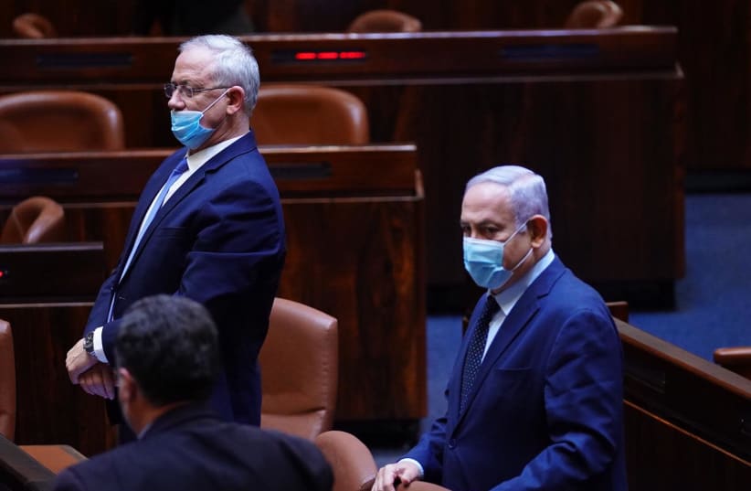 Prime Minister Benjamin Netanyahu and Alternate Prime Minister Benny Gantz arrive at the Knesset plenum to vote on four no confidence votes against the government (photo credit: KNESSET PRESS SERVICE/ADINA VALMAN)
