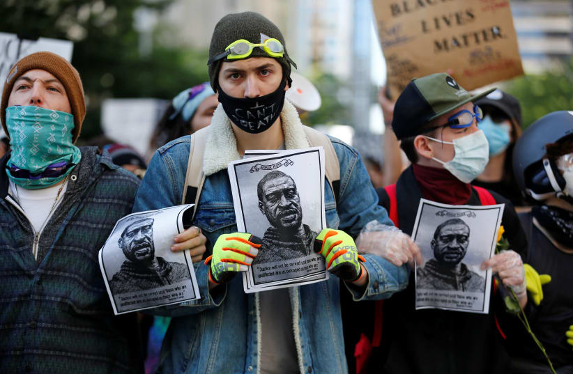 Protesters rally against the death in Minneapolis police custody of George Floyd, in Seattle (photo credit: REUTERS)