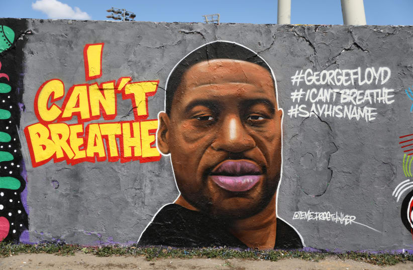 A mural depicts African-American man George Floyd, who died in Minneapolis police custody, at Mauerpark in Berlin, Germany, May 30, 2020. (photo credit: REUTERS)