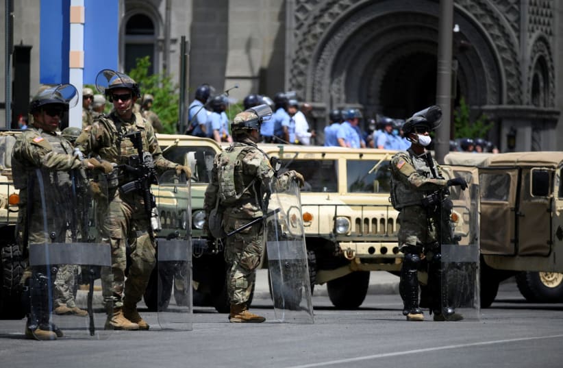 National Guard assist the Philadelphia Police Department in controlling the area near City Hall and the Municipal Services Building during a march by protesters against the death in Minneapolis police custody of George Floyd in Philadelphia, Pennsylvania June 1, 2020 (photo credit: REUTERS/BASTIAAN SLABBERS)