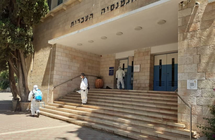 Jerusalem municipality workers exit a city school following disinfection. June 3, 2020.  (photo credit: COURTESY JERUSALEM MUNICIPALITY)