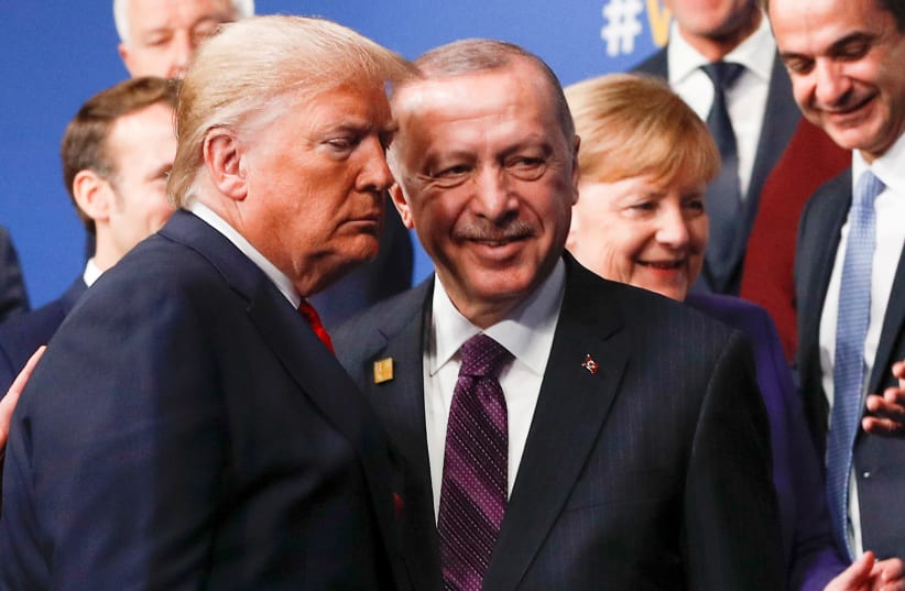 U.S. President Donald Trump and Turkey's President Recep Tayyip Erdogan leave the stage after family photo during the annual NATO heads of government summit at the Grove Hotel in Watford, Britain December 4, 2019 (photo credit: REUTERS/PETER NICHOLLS)