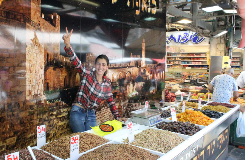 SARA, A local resident and shuk employee, is glad just to be back at work. (photo credit: BARRY DAVIS)