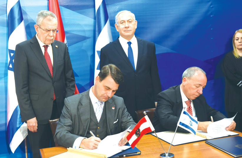 PRIME MINISTER Benjamin Netanyahu and Austrian President Alexander Van der Bellen oversee the signing of agreements between the two countries in Jerusalem last year (photo credit: DEBBIE HILL/REUTERS)